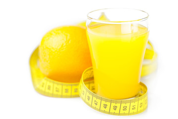 measuring tape,orange and a glass of orange juice isolated on wh