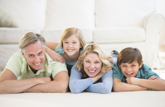 Family Lying On Floor At Home