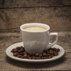 Coffee cup over a wooden background