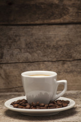 Coffee cup over a wooden background