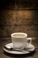 Coffee cup over a wooden background
