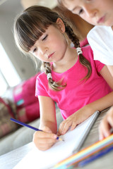 Portrait of kids at home drawing with pencils