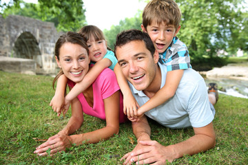 Fototapeta premium Portrait of parents with kids on their back