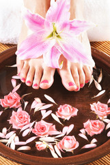 Spa compositions of sexy female feet and beautiful flowers