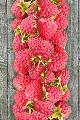 Raspberry against the background of wooden boards.