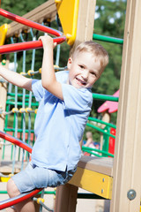 Fototapeta na wymiar Little boy playing on a playground