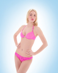 Fototapeta premium A young and sexy blond woman in a pink bikini swimsuit