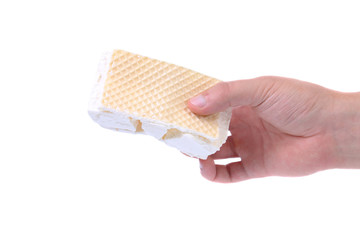 Hand holds the broken vanilla ice cream.