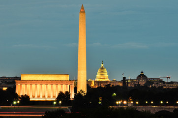 Washington D.C. skyline at night with major monuments including Lincoln Memorial and Washington...