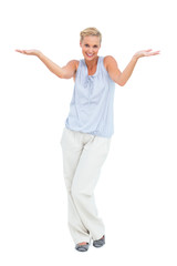 Blonde woman with arms raised in question