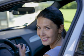 young woman sitting in her car