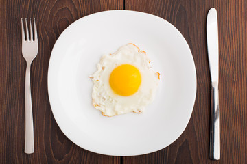Fried egg on white plate