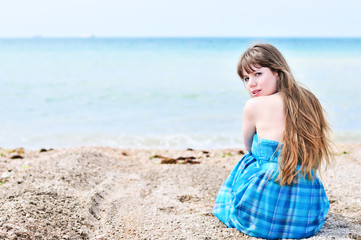 Fototapeta na wymiar woman sitting alone at the beach