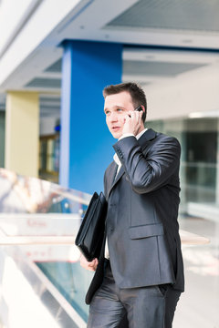 Handsome young businessman talking on his mobile