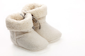 Pair of baby booties over white