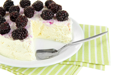 Cheesecake with fresh berries on white plate closeup