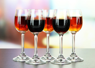 Glasses of liquors, on bright background