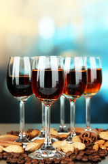 Glasses of liquors with almonds and coffee grains,