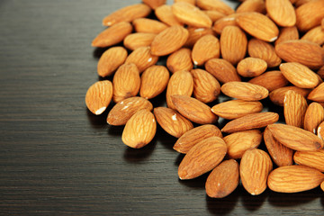 Almond on dark wooden background
