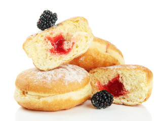Tasty donuts with berries, isolated on white