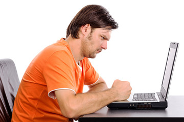 Angry young man at his laptop