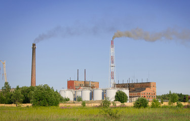 Fototapeta na wymiar Working electric power plant over blue sky.