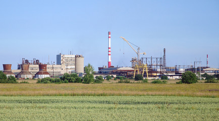Fototapeta na wymiar Electric power plant over blue sky.