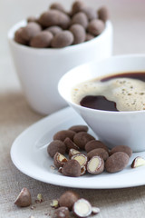 Breakfast with coffee and chocolate covered almonds