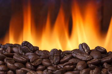 Coffee beans roasting with fire on background