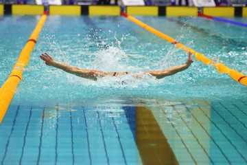 Front view of woman swims in swimming pool