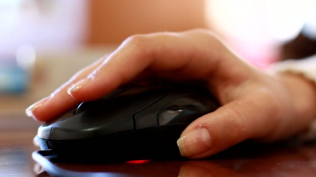 hand clicking computer mouse