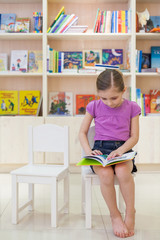 The girl in the library reading a book intently