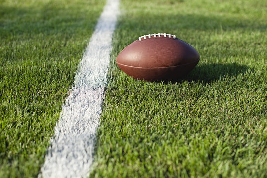 Football on grass field at goal or yard line