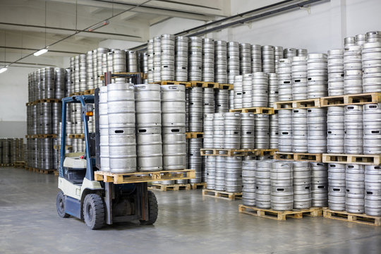 Autoloader loading beer kegs in stock brewery