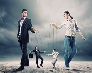 Businesspeople with marionettes