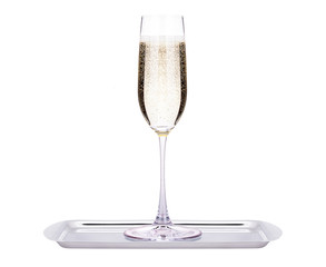 glass of champagne on a tray isolated