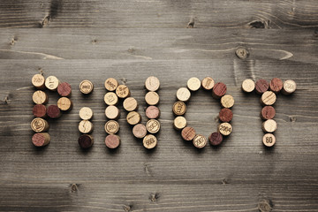 "PINOT" written with corks