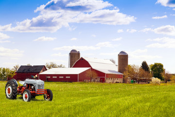 Fototapeta premium Traditional american red farm with tractor