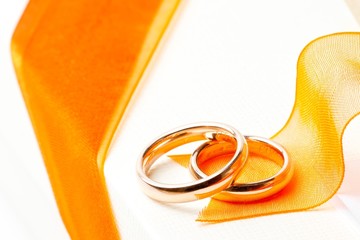 gold wedding rings orange ribbon