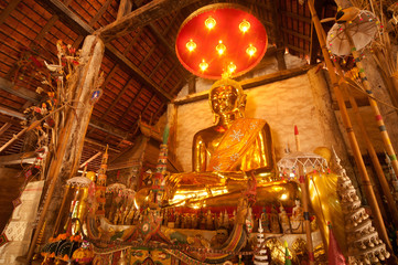 Golden sitting Buddha in Thai temple.