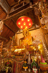 Golden sitting Buddha in Thai temple.