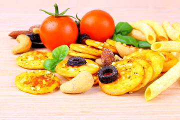 Snack, pizza crackers, dried olives, nuts, tomatoes