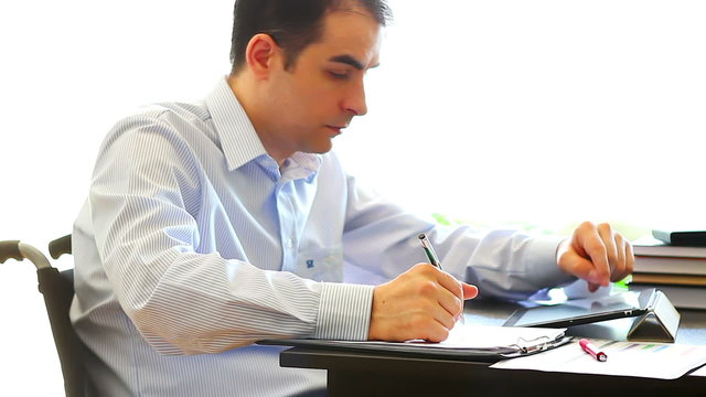 Office worker in wheelchair with tablet computer