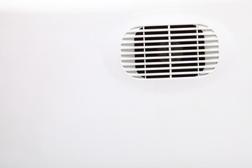 plastic air vent in white wall ventilation grille