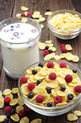 Cornflakes with berries and cup of milk