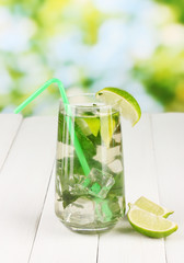 Mojito on wooden table on bright background