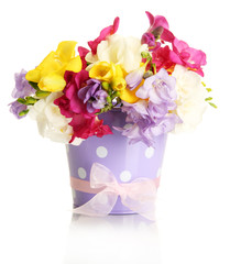 Beautiful bouquet of freesias in pail, isolated on white