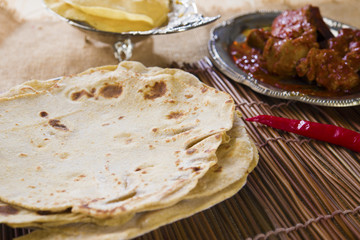 Chapatti roti, curry chicken, biryani rice, salad, masala milk t