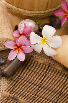 tropical spa setup with traditional frangipani flower and massag