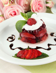 Tasty jelly dessert with fresh berries, on pink roses